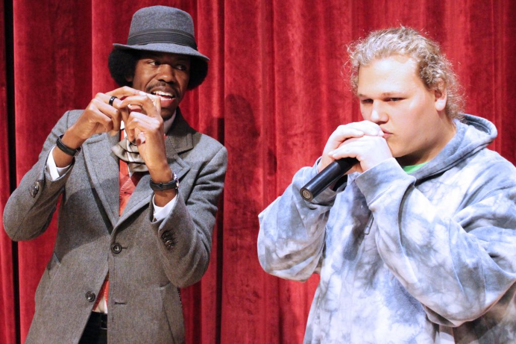 Pictured from left: Following the workshop, Christylez Bacon invited Riley Whitfield on the stage to hear the student’s beatboxing skills. The JMHS senior learned new techniques from Bacon to enhance his presentation.