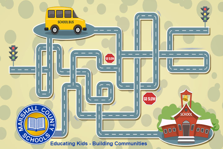 Yellow cartoon school bus following a road to a red school. Slow down signs are along the route. The Marshall County Schools circle blue and yellow logo is in the bottom left-hand corner.