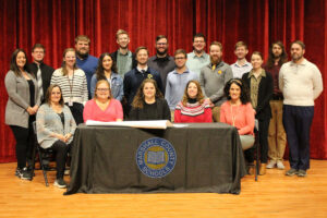 Cutline: The Marshall County Schools Music educators are pictured with Dr. Haines. From left front row: Sue Lewicki, Leslie Tedesco, Dr. Shelby Haines, Tracey Filben and Kathy Fox. Middle row: Dawn Boyd, Laura Oswalt, Rachel Price (student teacher), Keenan Seditz, Eli Lambie, Christian Oliver, Julianna Perkowski (student teacher) and David Scherrick. Back row: Michael Murphy, Evan Williams, Stephen Oswalt, Joshua Garrett, Shaun Hancher, Justin Jones and Alex Talkowski. Not pictured: Ashley Elliott.