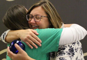 Alexa Bushovisky shares a joyful hug with Kathleen Loughman, Science Department Chair, after being surprised to learn that Kathleen nominated her for the Above and Beyond Award.